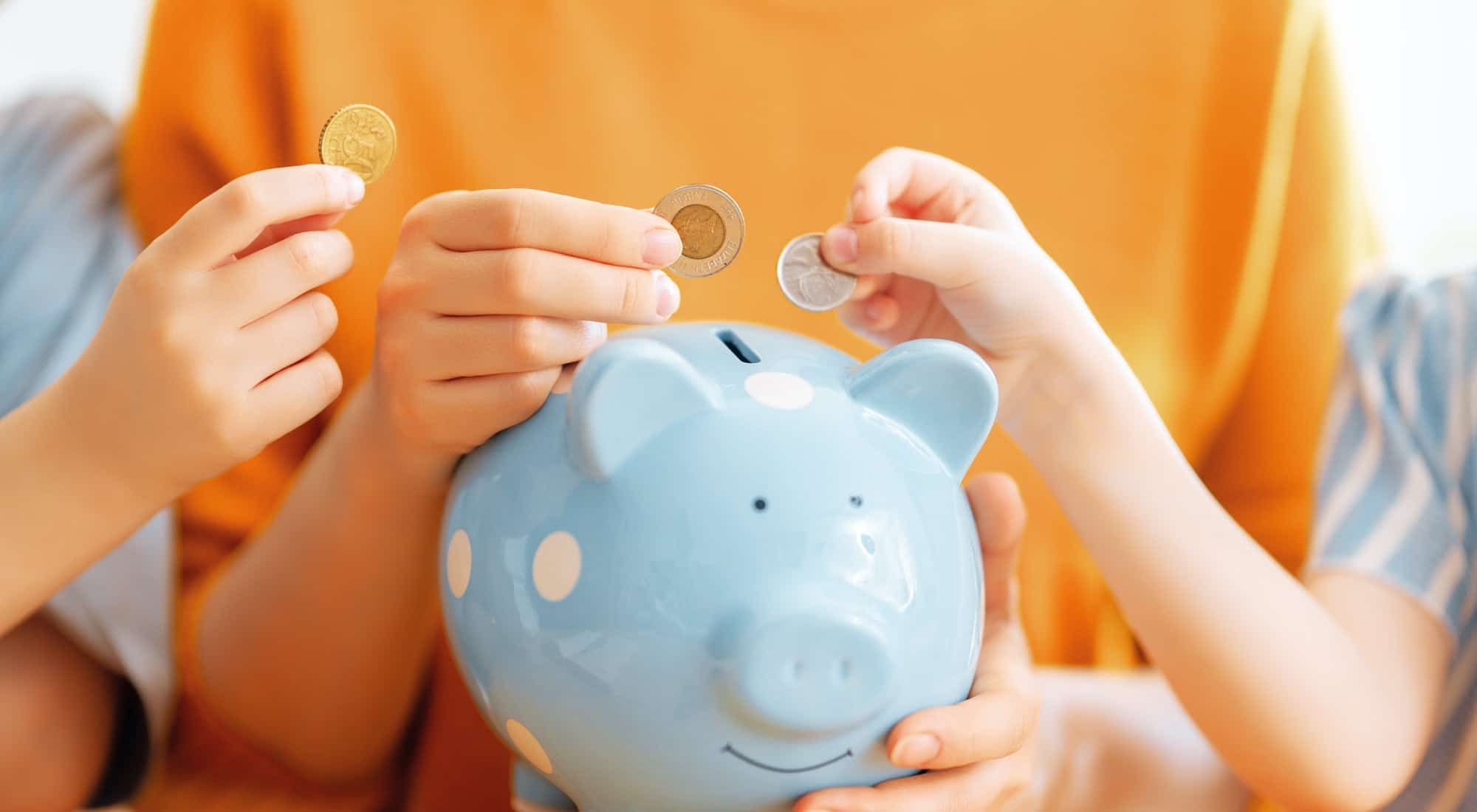 Woman and children with a piggy bank